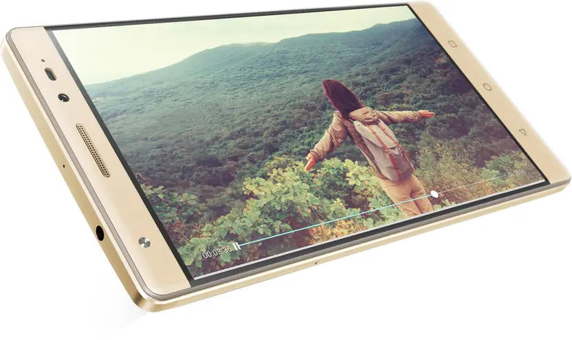 Close-up angled view of a gold-colored tablet or phone displaying an outdoor nature video of a person with arms outstretched, with warm earthy tones and soft natural light.